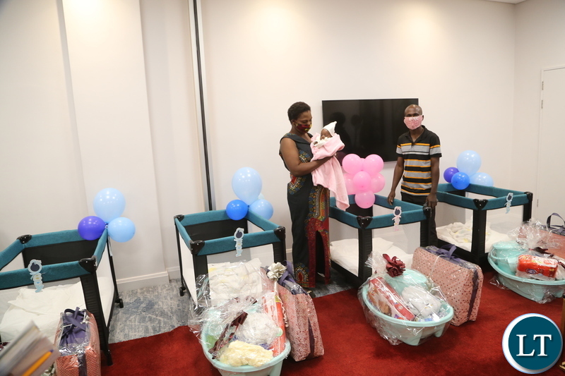 Mother of quadrato (4) babies Elizabeth Phiri Bwalya and Father Daniel Bwalya admiring presents given to there babies Edgar, Jeremiah, Jessy and the only female Esther