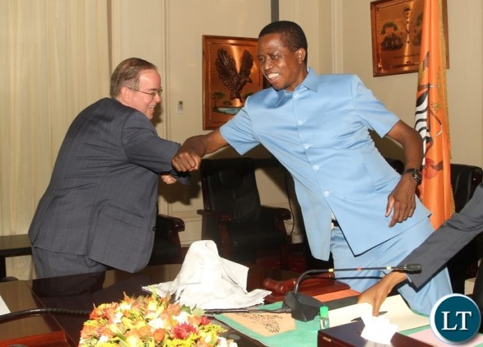 President Edgar Lungu in an elbow greeting with U.S Embassy Charge'd'Affaires, David Young during the commemoration of the U.S Government's commitment to implement a five- year k39 billion ($1.9 billion) development strategy for Zambia at State House. Picture by SUNDAY BWALYA/ZANIS President Edgar Lungu in an elbow greeting with U.S Embassy Charge'd'Affaires, David Young during the commemoration of the U.S Government's commitment to implement a five- year k39 billion ($1.9 billion) development strategy for Zambia at State House. Picture by SUNDAY BWALYA/ZANIS