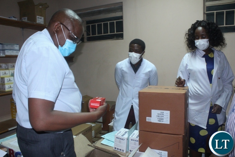 Ministry of Health Technical Services Permanent Secretary Dr. Kennedy Malama(l) going through the drugs at Mongu District Hospital Pharmacy as hospital medical officer in-charge Dr. Chilufya Musonda (c) and Pharmacist Diana Uyoya (r) look on during the tour of health facilities in Mongu