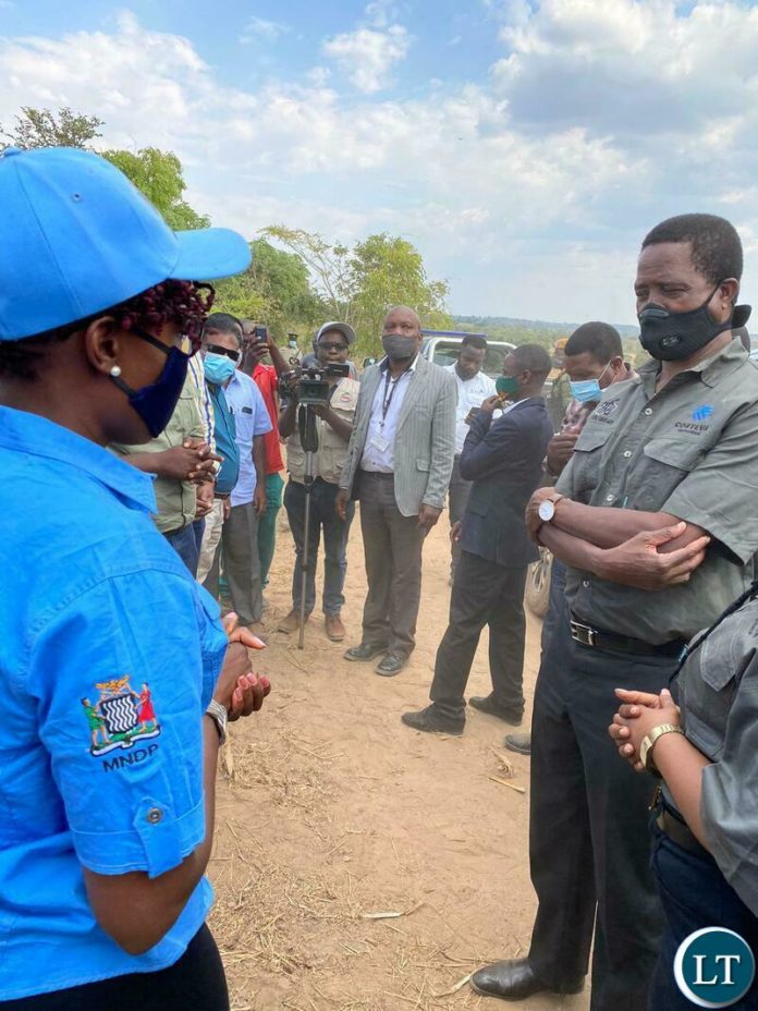 Zambia Integrated Forest Landscape Project (ZIFLP) National Coordinator Dr. Tasila Banda (in blue ZIFLP MNDP shirt and cap) welcoming and explaining to His Excellency Dr. Edgar Chagwa Lungu, President of the Republic of Zambia, about ZIFLP's undertakings and support to farmers in Eastern Province. His Excellency the President was also shown the cashew trees and had an opportunity to listen and hear beneficiary farmers' experiences. This was in Petauke District where the Head of State launched the 2020/2021 National Crop Planting season on Thursday 19 November 2020. President Lungu was on a working visit to Eastern Province until Sunday 22 November 2020. Photos courtesy of MNDP Zambia Integrated Forest Landscape Project (ZIFLP) National Coordinator Dr. Tasila Banda (in blue ZIFLP MNDP shirt and cap) welcoming and explaining to His Excellency Dr. Edgar Chagwa Lungu, President of the Republic of Zambia, about ZIFLP's undertakings and support to farmers in Eastern Province. His Excellency the President was also shown the cashew trees and had an opportunity to listen and hear beneficiary farmers' experiences. This was in Petauke District where the Head of State launched the 2020/2021 National Crop Planting season on Thursday 19 November 2020. President Lungu was on a working visit to Eastern Province until Sunday 22 November 2020. Photos courtesy of MNDP