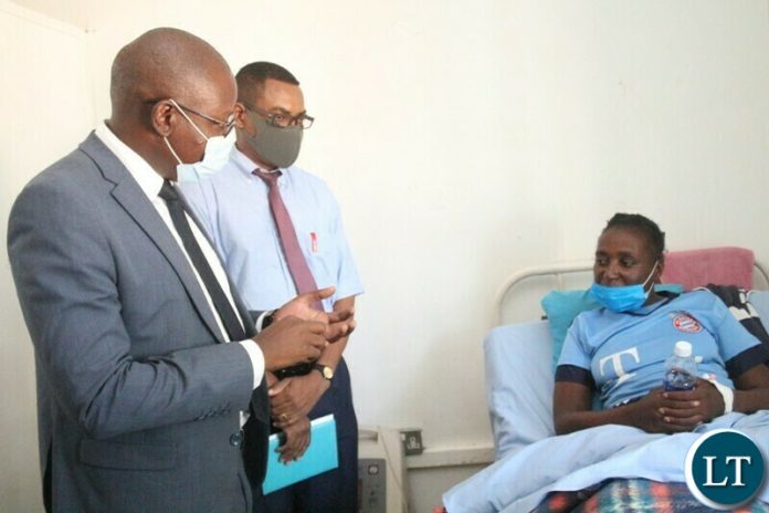 NATIONAL Health Insurance Management Authority (NHIMA) Director General James Kapesa talks to a patient under NHIMA scheme Orient Handindo at Choma General hospital. Looking on is Choma general hospital Medical Superintendent Dr. George Chipulu (c). This was when NHIMA Top officials inspected the departments under NHIMA scheme in Choma on Wednesday.