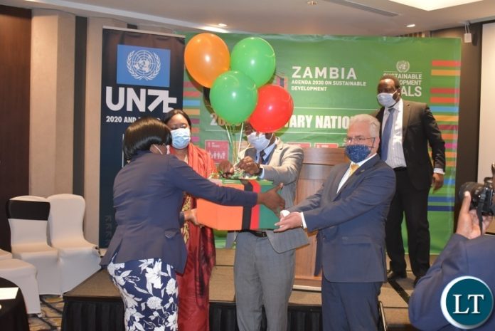 1 MNDP PS Danies Chisenda - centre, UN Res. Co. Dr Coumba Mar Gadio and UNDP Res. Rep Lionel Laurens display Zambia SDGs review report MNDP PS Danies Chisenda - centre, UN Res. Co. Dr Coumba Mar Gadio and UNDP Res. Rep Lionel Laurens display Zambia SDGs review report