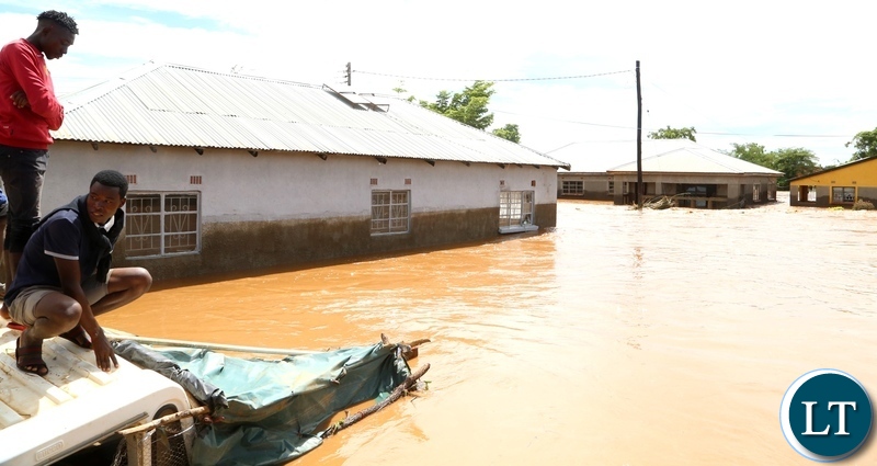 Same Mumbwa residents watch there submerged house hopeless after the Kandesha dam burst it banks causing the flash floods yesterday. Sunday, December 27, 2020. Picture by ROYD SIBAJENE/ZANIS