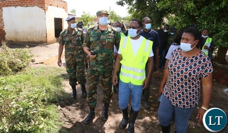  Minister in the Office of the Vice President Olipa Phiri flanked by DMMU national coordinator Chanda Kabwe and defence force officers visiting the flooded homes in Mumbwa District after the Kandesha dam burst it banks yesterday. Sunday, December 27, 2020. Picture by ROYD SIBAJENE/ZANIS