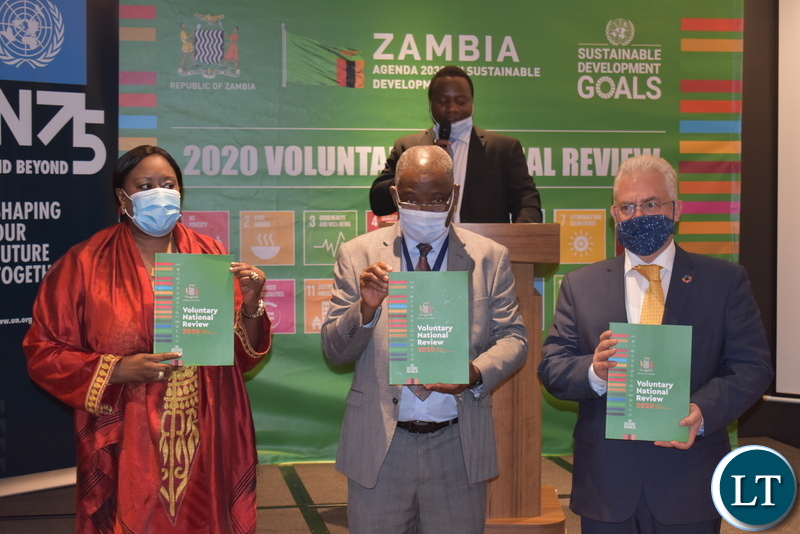 MNDP PS Danies Chisenda - centre, UN Res. Co. Dr Coumba Mar Gadio and UNDP Res. Rep Lionel Laurens display Zambia SDGs review report