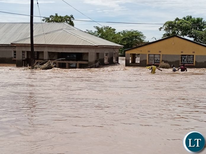 DMMU National coordinator Chanda Kabwe in a yellow reflector and his team being shown where the flood water come from up hill dam in Mumbwa DMMU National coordinator Chanda Kabwe in a yellow reflector and his team being shown where the flood water come from up hill dam in Mumbwa