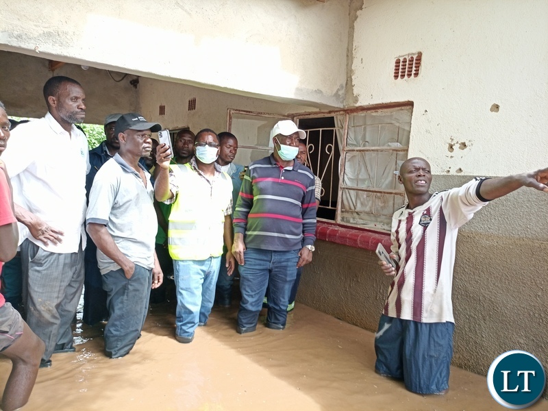 DMMU National coordinator Chanda Kabwe checking one of the flooded house in Mumbwa