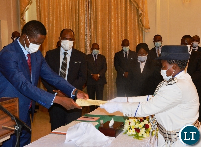 President Edgar Lungu receive a letter of Oath from Newly appointed Deputy Inspector General Of Police in Charge of Operations Charity Katanga during a swearing in Ceremony at State House
