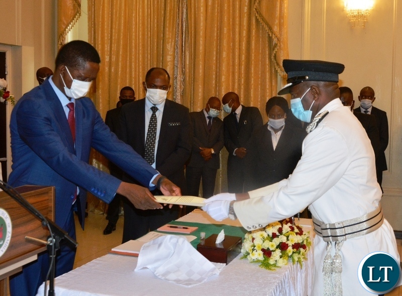 President Edgar Lungu receive a letter of Oath from newly appointed Deputy Inspector General Of Police in Charge of Administration Richard Mweene during a swearing in Ceremony at State House