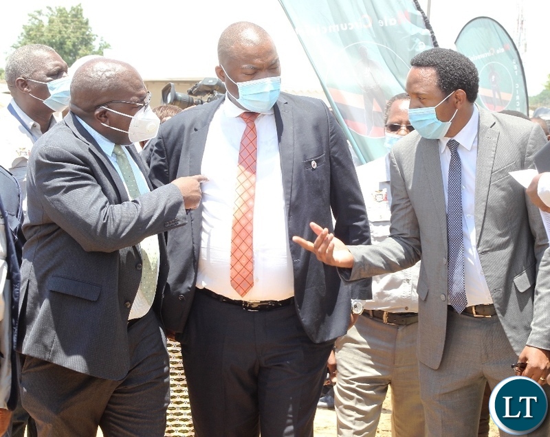 Minister of Health, Chitulu Chilufya(L) in a conversation with Dr.Patrick Lungu(r) while Lusaka Province Minister, Bowman Lusambo looks on, during world Aids day in Lusaka