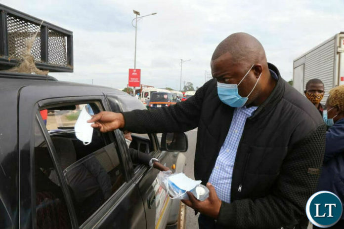 Lusaka Province Minister Bowman Lusambo handing out free face masks in Lusaka on Tuesday.