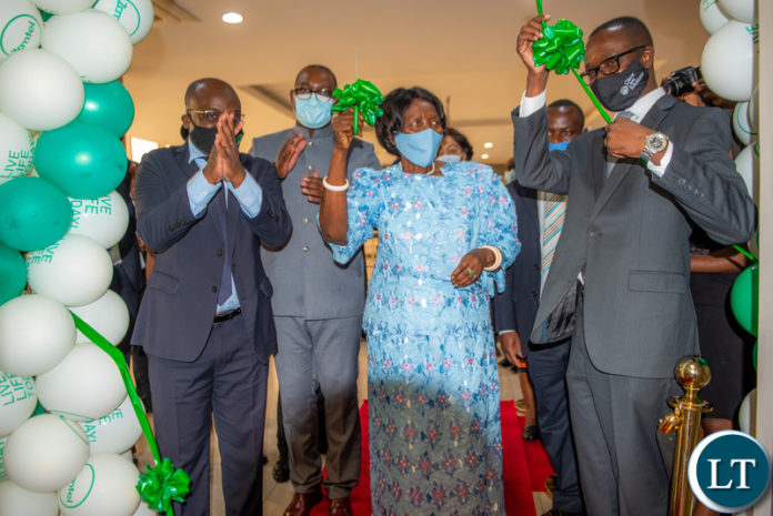 Vice President Inonge Wina cuts the ribbon during the ceremony for the hand over of Call Centre functions to Client Care Solutions Ltd