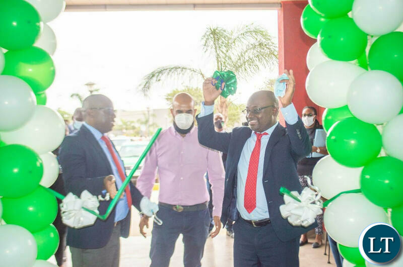 Zamtel CEO Sydney Mupeta cuts a ribbon to official opening of a Service Centre at Makeni Mall in Lusaka