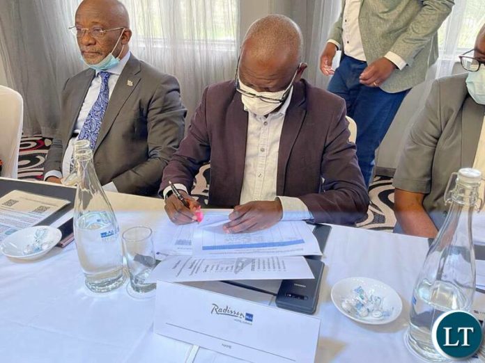 Signing paper work for the Kasomeno-Mwenda toll road and Luapula Bridge Project