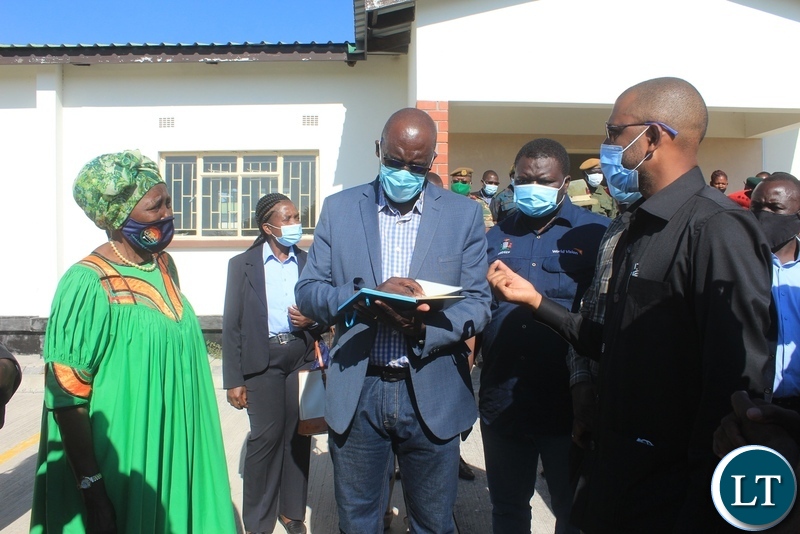 Infrastructure Minister Vincent Mwale (r) assures Vice President Inonge Wina (l) that only about K200, 000 remaining to pay the contractor as Finance Minister Bwalya Ng’andu (c) take notes during assessing of the work progress for the new district administration block for Limulunga District