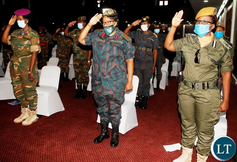 Women in uniform from the security wings salute as they sing the National Anthem during the commemoration of this year's International womens day at Mulungushi Conference centre in Lusaka. Picture by SUNDAY BWALYA/ZANIS