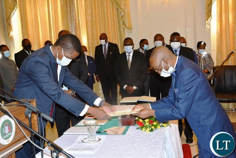 Justice Mwila Chitabo handing in his affidavit of oath to President Lungu when he was sworn in as Constitutional Court Judge at State House