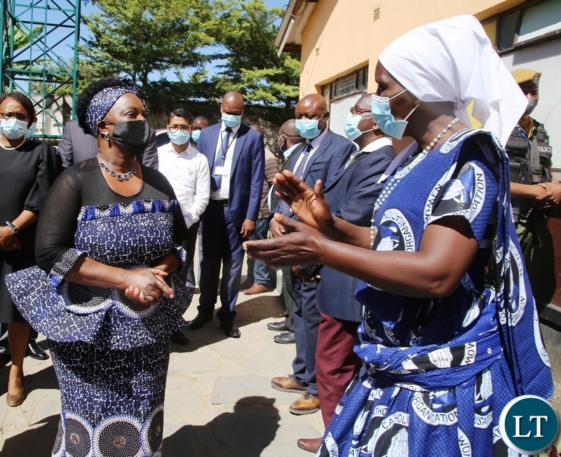 ST Kizito Parish Women Council Chairperson Mary Mukuka shares a light moment with First lady Esther Lungu when she officiated at a donation of food hampers in George Compound in Lusaka. Picture by SUNDAY BWALYA/ZANIS