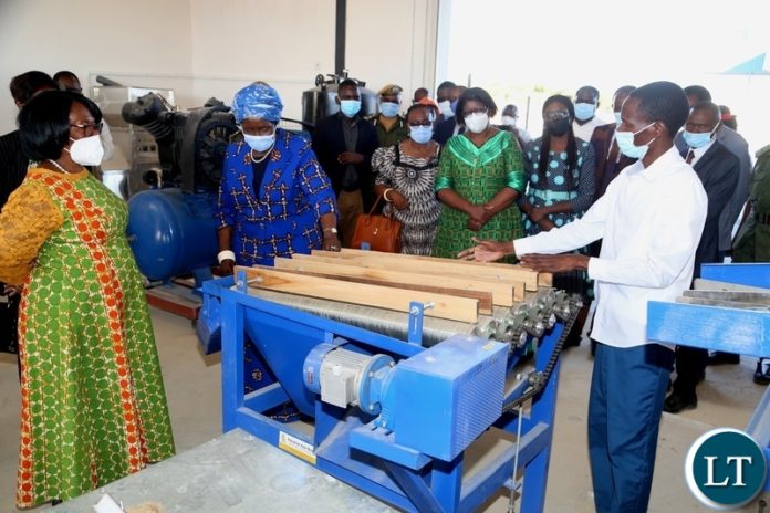 Mr. Manyando Manyando explains on the machines to the Vice President Inonge Wina and her encourage listens during the tour of the industrial yard in Mongu yesterday. Thursday, May 27, 2021. Picture by ROYD SIBAJENE/ZANIS Mr. Manyando Manyando explains on the machines to the Vice President Inonge Wina and her encourage listens during the tour of the industrial yard in Mongu yesterday. Thursday, May 27, 2021. Picture by ROYD SIBAJENE/ZANIS