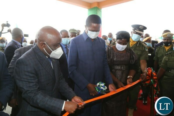 President Edgar Lungu with Home Affairs Minister Steven Kampyongo(l)Gender Minister Elizabeth Phiri(r) and Inspector General of Police Kakoma Kanganja cuts the ribbon to officially Commission Kanyama Police Station in Lusaka