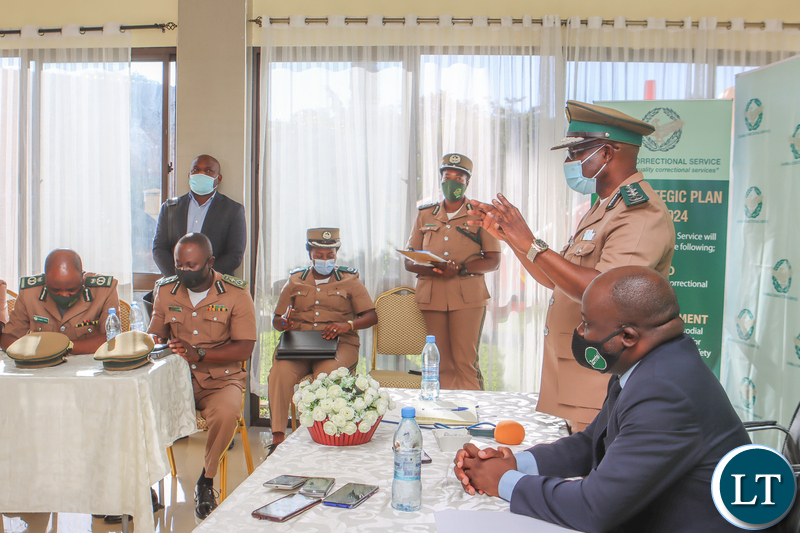 Zambia Correctional Service Commissioner General Dr Chisela Chileshe addresses members of his top command during the signing ceremony as Zamtel CEO Sydney Mupeta listens on