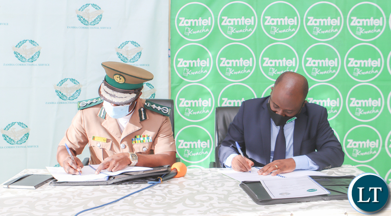 Zambia Correctional Service Commissioner General Dr Chisela Chileshe and Zamtel CEO Mr Sydney Mupeta during the signing ceremony of an MoU to digitalise operations of the Correctional Service