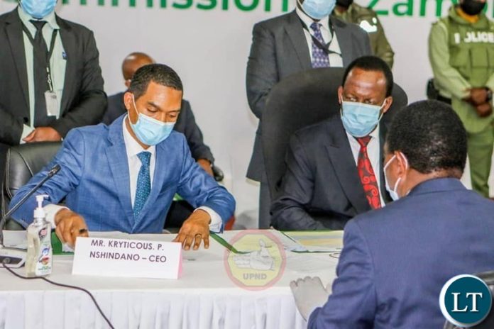 ECZ Chief Electoral Officer Patrick Nshindano receiving credentials from HH