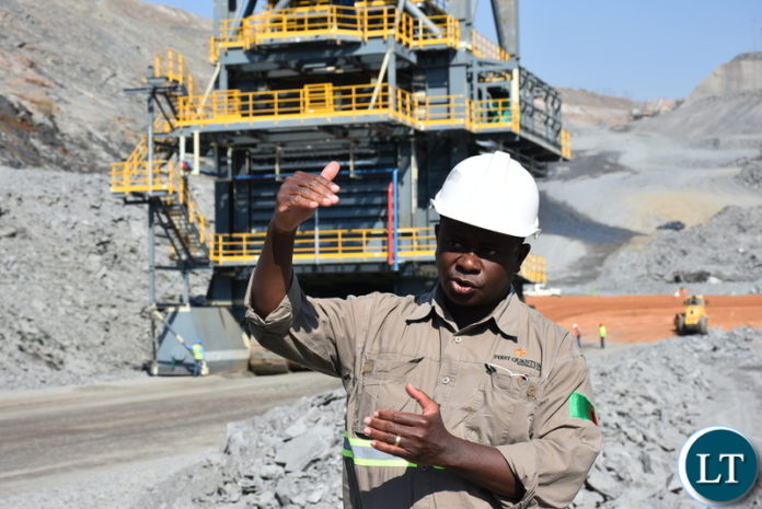KALUMBILA Minerals Limited Project Manager for CR4 Pocket Construction Albert Jonah explains the effectiveness of the In-pit ore crushers at Kalumbila Open pit mine. – Picture by Derrick Silimina/SUMA SYSTEMS.