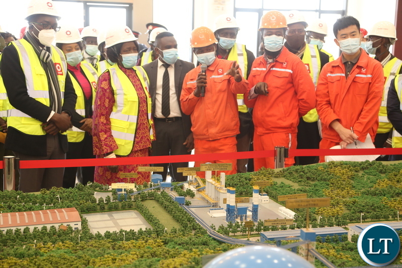 Mr.Paikani Banda shows the Vice President Inonge Wina and her entourage the map of the Sinoma Cement factory during the tour of the Sinoma Cement in Chongwe District yesterday. Tuesday, June 8, 2021. Picture by ROYD SIBAJENE ZANIS