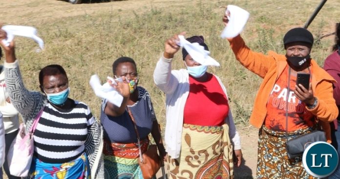 Ndola residents mourn the late first Zambian President Dr Kenneth Kaunda by waving white handkerchiefs a symbol for the late when the remains where being driven through Ndola town yesterday. Monday, June 28, 2021. Picture by ROYD SIBAJENE ZANIS