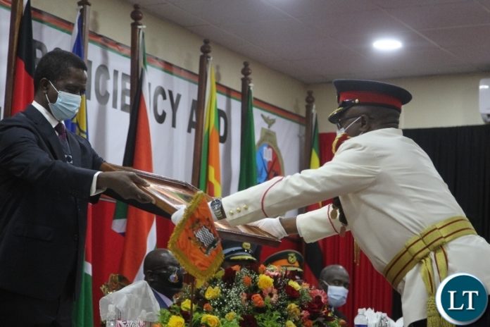 President Edgar Lungu gives a recognition award to Zambia Army Commander ,LT.General William Sikazwe during the silver jubilee celebration and official launch of the new staff college and National Defence University in Lusaka. President Edgar Lungu gives a recognition award to Zambia Army Commander ,LT.General William Sikazwe during the silver jubilee celebration and official launch of the new staff college and National Defence University in Lusaka.