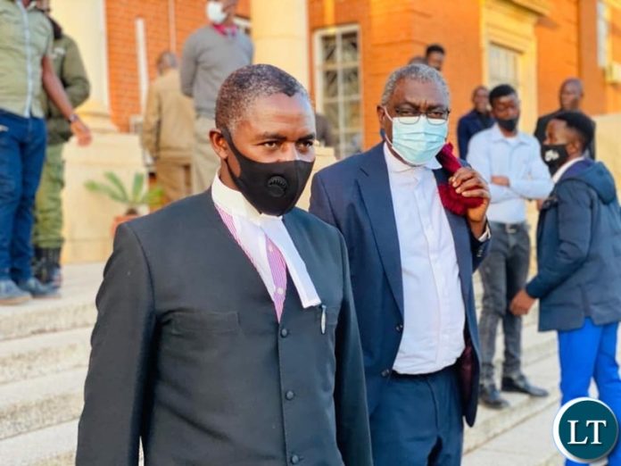 State Counsel Sakwiba Sikota (R) after the court Session
