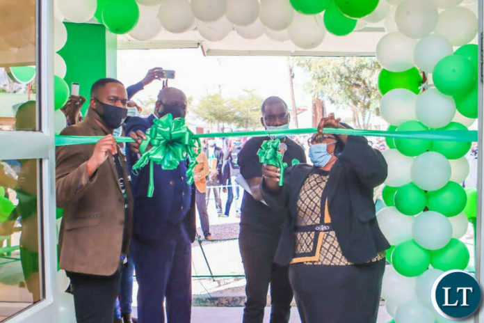 Southern Province Permanent Secretary Joyce Bwacha cuts a ribbon to officially open a Zamtel Customer Service Centre in Choma.