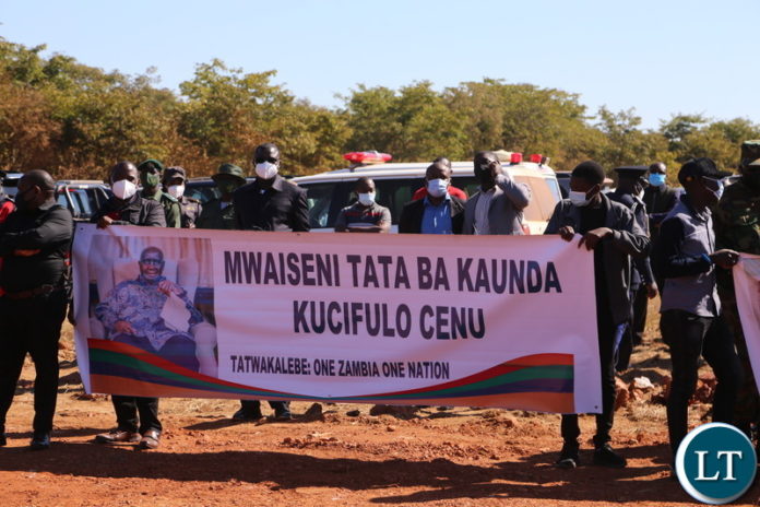 Muchinga resident with the banner receiving the remains of late first Zambian President Kenneth Kaunda when the body arrived at Muchinga Airtrip