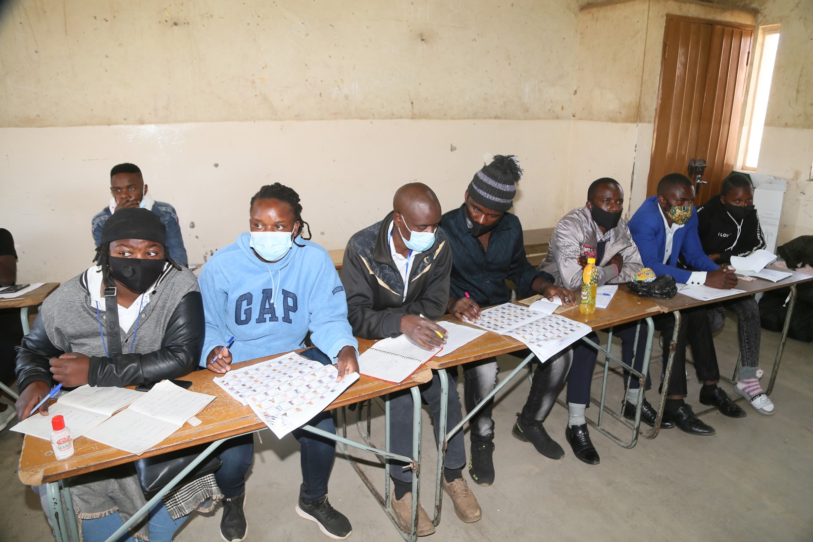 Polling assistants verifying the names of voters at Kamulanga Primary School in Kabwata Constituency
