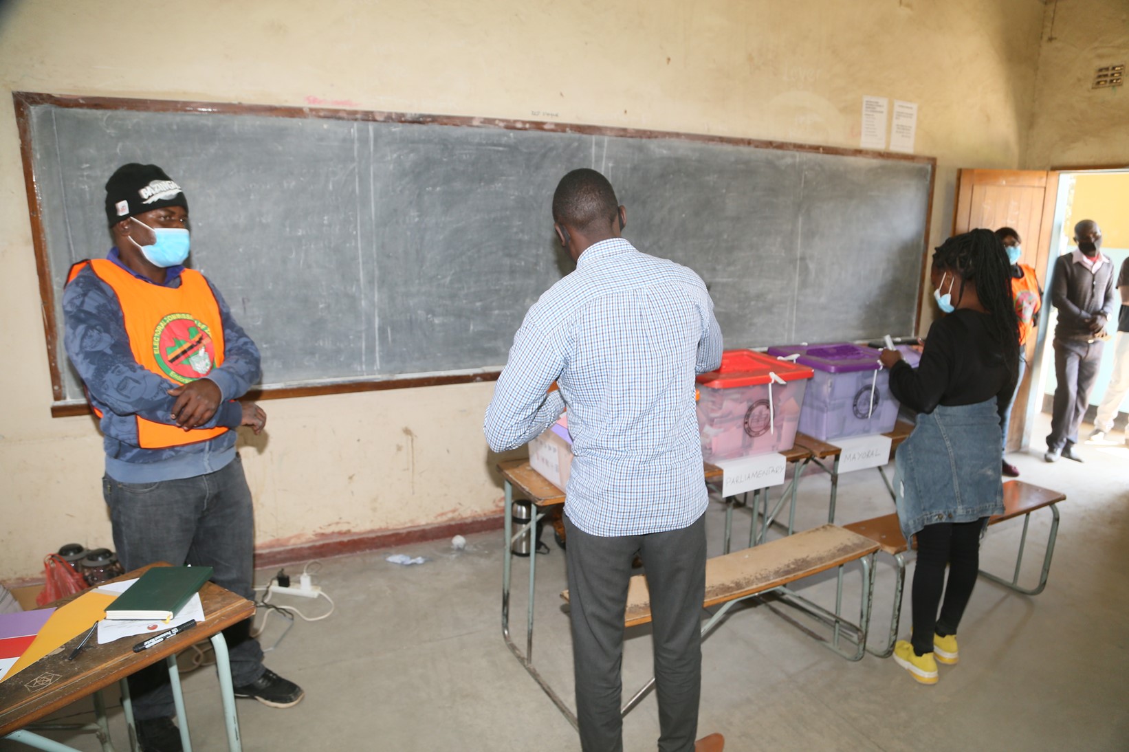 Kamulanga Primary School Polling Station Polling Officer  Mr. Nkhata making sure voters are doing the right things at Kamulanga Primary School in Kabwata Constituency