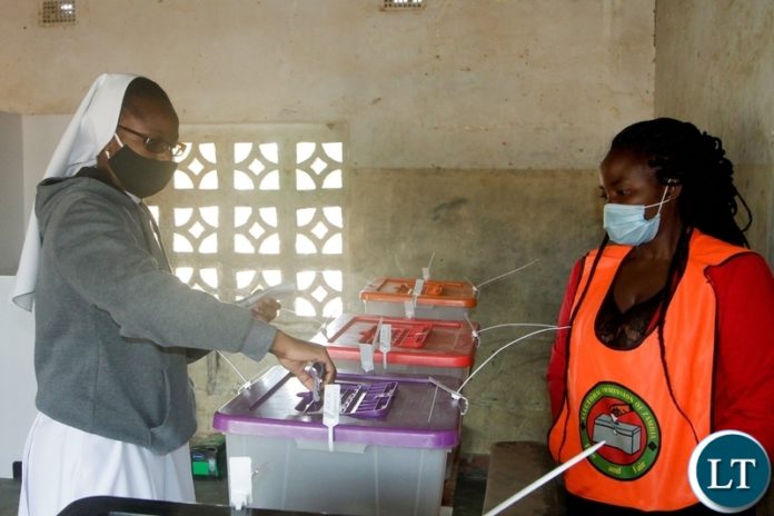 A- Catholic Nan casting her vote at Mansa Basic School Polling Station in Bahati constituency.