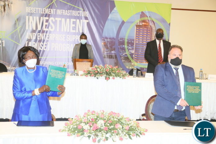 Vice President Inonge Wina and Secretary to the Treasury Fredson Yamba posing for the picture after signing the concession agreement between the Government of Zambia and Nkhulu Zambia limited for implementing the Agreement Resettlement Infrastructure Investment and Enterprise Support (ARIISE) program at Pamondzi Hotel in Lusaka yesterday. Tuesday, August 10, 2021. Picture by ROYD SIBAJENE ZANIS