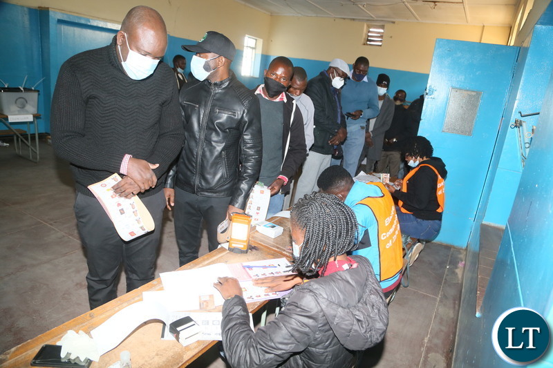 Polling assistants verifying the names and NRC from the voters at silverest polling in Chongwe District