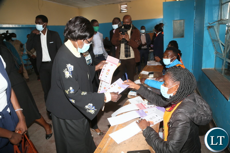 Vice President Inonge Wina receive the ballot papers from the polling assistant at silverest polling in Chongwe District 