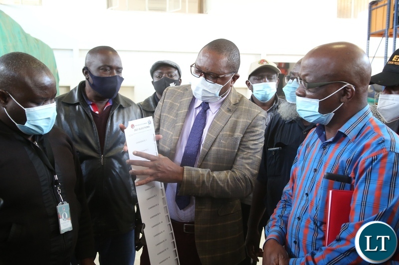 Electoral Officer ,Alick Chakawa showing Political party stakeholders Presidential ballot papers during the verification of 2021 general election in Lusaka.