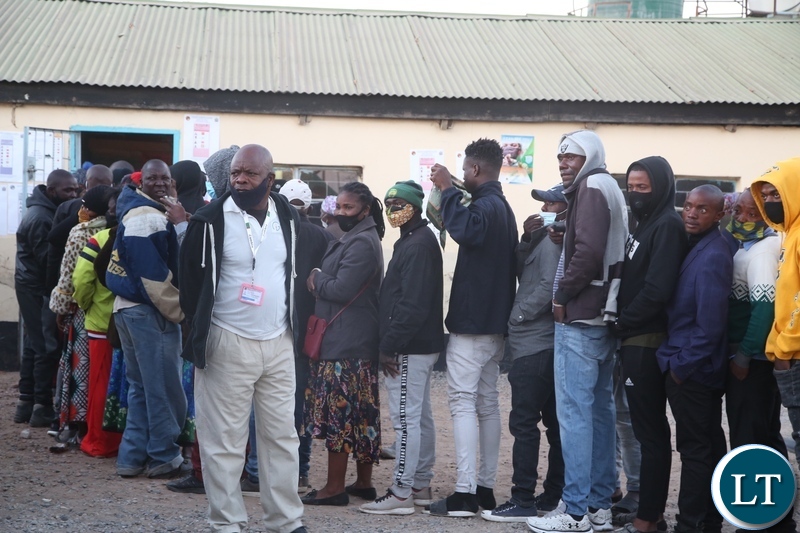 Chawama residents line up to cast their votes at Andrew Mwenya polling station in Chawama today.