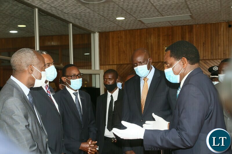President Hakainde Hichilema flanked by Secretary to the Cabinet  Dr. Simon Miti confers with staff of Mulungushi Conference Center during the induction of Cabinet Ministers and Provincial Ministers. Monday, September 13, 2021.  Picture by ROYD SIBAJENE/ZANIS