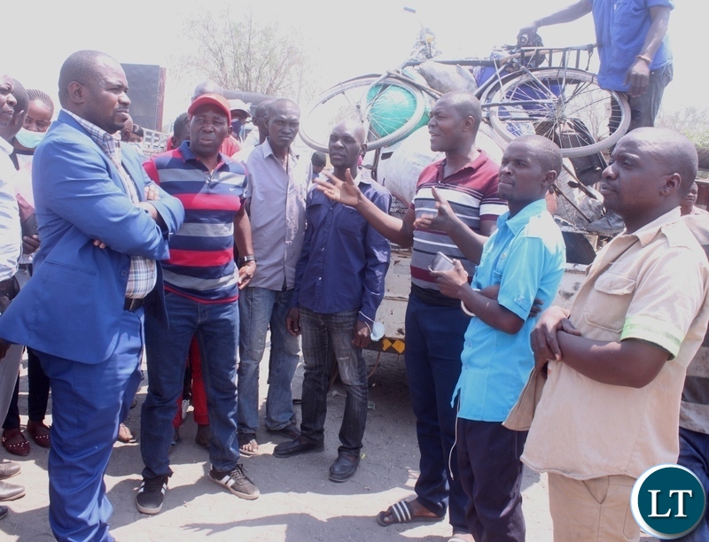 A driver at Mongu Central Market Kelvin Mukumbuta (gesture) appealing to Mongu Mayor Nyambe Matakala (blue suit) not to entertain criminals in markets shortly before addressing the marketeers in Mongu Western Province