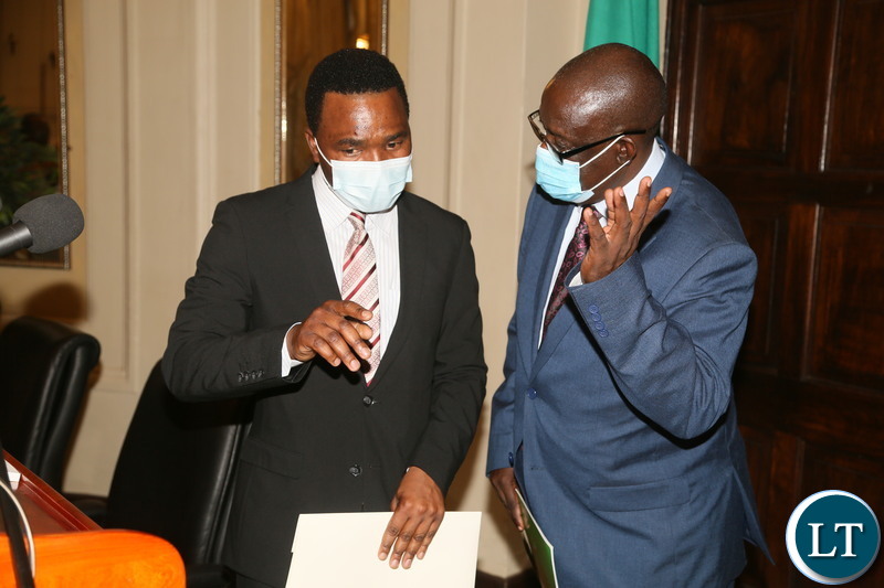 Special Assistant to the President for Press and Public Relations Anthony Bwalya confers with Permanent Secretary State House Dr. Oliver Kalabo during press briefing at State House