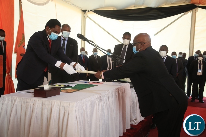 PRESIDENT Hakainde Hichilema receives an affidavit form from Newly sworn in Minister of Lands Richard Muchima at swearing -in ceremony in Lusaka.