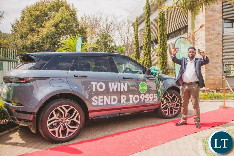 Kelvin Bandela, winner of the Win a Range Rover promotion poses in front of his new car