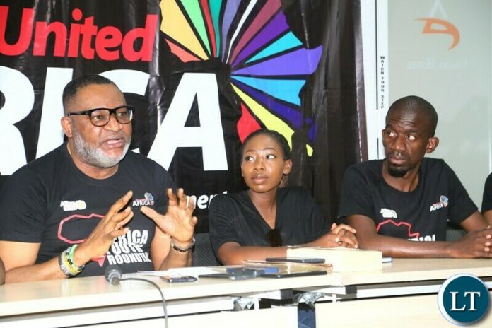 -Initiator, One united Africa Congressman Bimbo Daramola speaking to Journalists during the media briefing in preparation of celebrating African Union Youth Day which falls in 1st November, 2021 whilst One Africa Organnising team Mwangala Sipumo (c) and One united Africa Member George Chishimba looks on at Asmara hotel in Lusaka