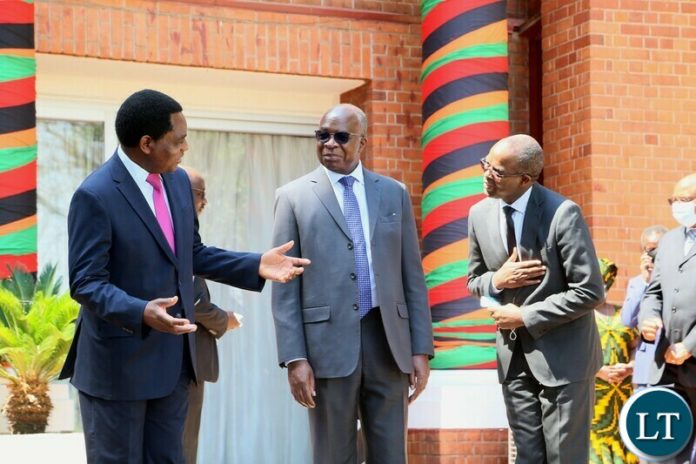 President Hakainde Hichilema confers with Zambia Revenue Authority Dingani Banda whilst Minister of Finance Situmbeko Musokotwane looks on shortly after swearing in ceremony at State House President Hakainde Hichilema confers with Zambia Revenue Authority Dingani Banda whilst Minister of Finance Situmbeko Musokotwane looks on shortly after swearing in ceremony at State House
