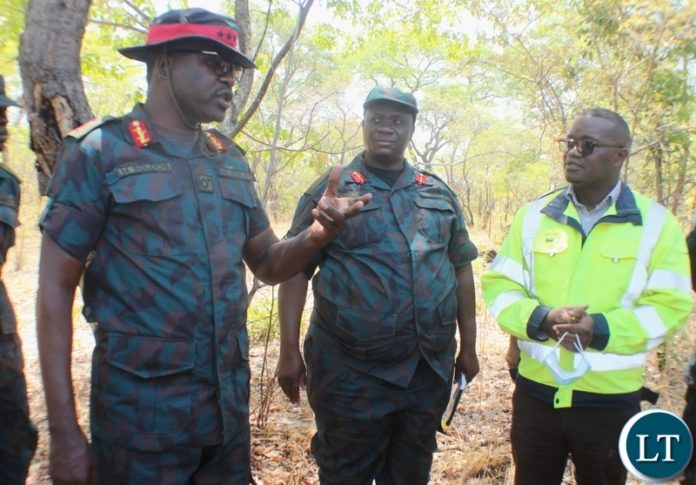 ZNS Commandant Lt. Gen. Maliti Solochi (l) directs RDA Western Province Regional Manager Paul Habasimbi (r) and ZNS Chief of Land Development Branch Jephan Mukanda (c) to re-strategies the plan in order to complete the project with quality and on time during the inspection of the project in Nalolo District, Western Province